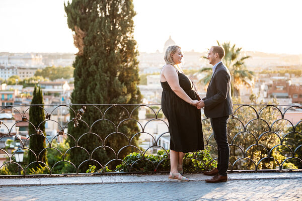 Couple holding hands on the Terrazza Belvedere before their surprise wedding proposal in Rome