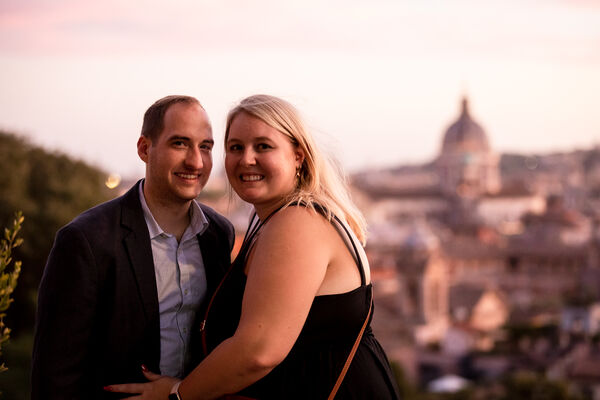 Newly-engaged couple on the Terrazza Belvedere after sunset during their surprise wedding proposal photo shoot in Rome
