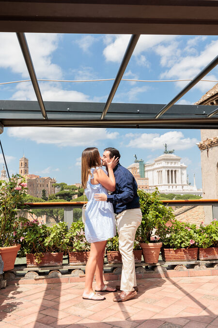 Couple kissing during their surprise proposal photo session in Rome