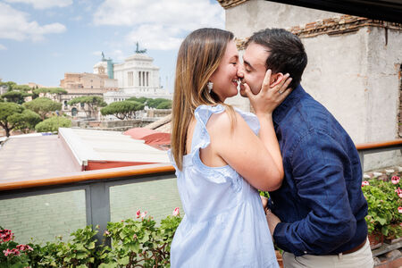 Newly-engaged couple kissing at the American Bar rooftop in Rome