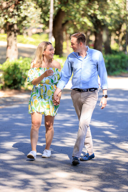 Newly-engagement couple holding hands walking in Villa Borghese in Rome