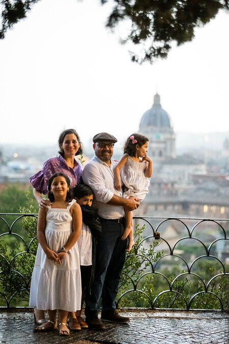 Beautiful family posing on the Terrazza Belvedere after a storm during their photo session in Rome