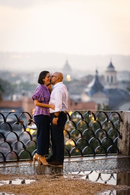 Future husband kissing his wife to be during their surprise marriage proposal photo shoot on the Terrazza Belvedere in Rome