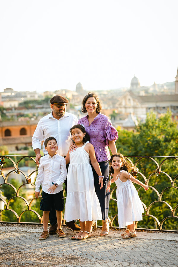 Happy family with 3 kids during on the Terrazza Belvedere in Rome