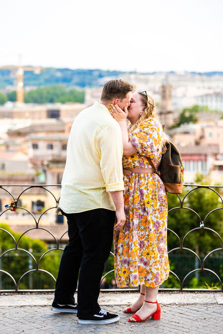 Newly-engaged couple kissing on the Pincian Hill in Rome