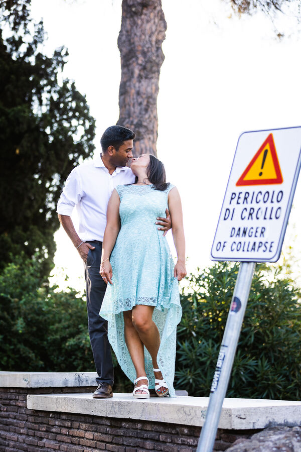 Happy newly-engaged couple kissing in Rome