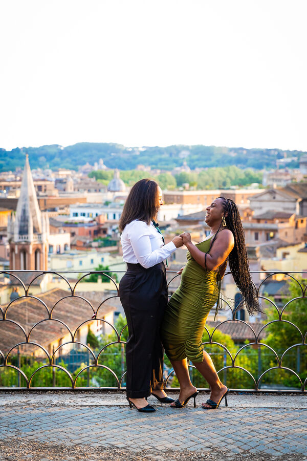 Happy couple during their surprise wedding proposal at sunset in Rome