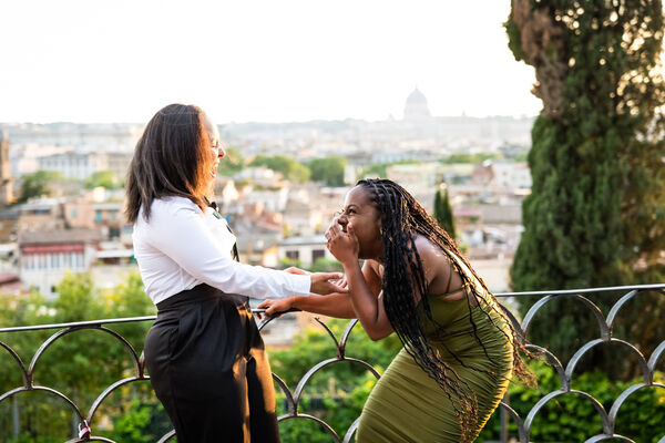Joyous lesbian couple during their surprise marriage proposal in Rome