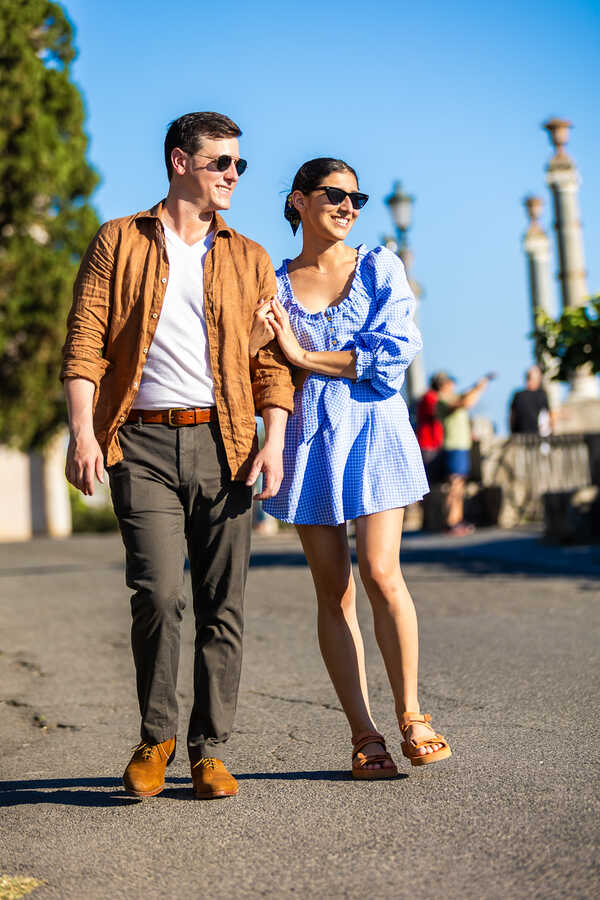 Newly-engaged couple walking on the Pincian Hill during their surprise proposal photoshoot in Rome