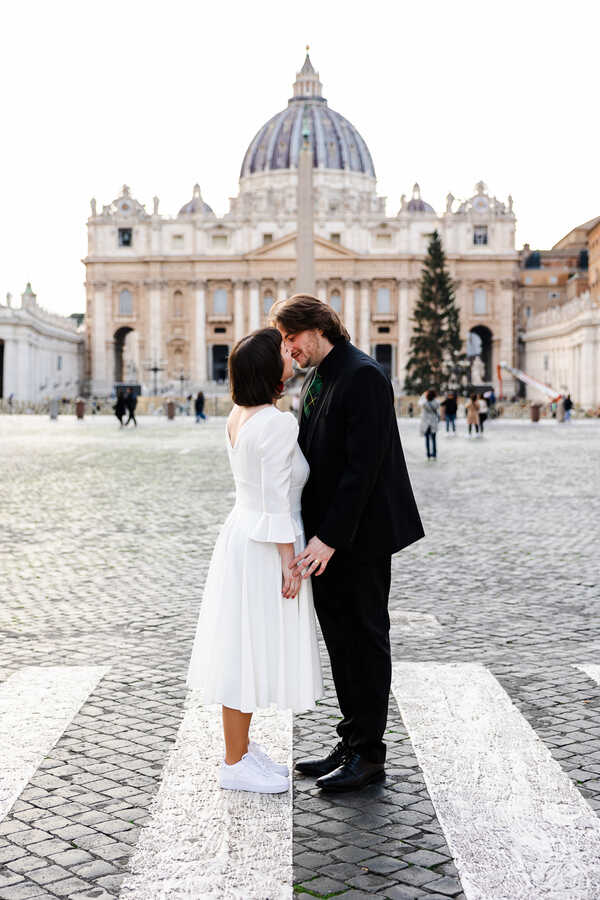 Sposi Novelli couple kissing in Via della Conciliazione during their Sposi Novelli photoshoot in Rome