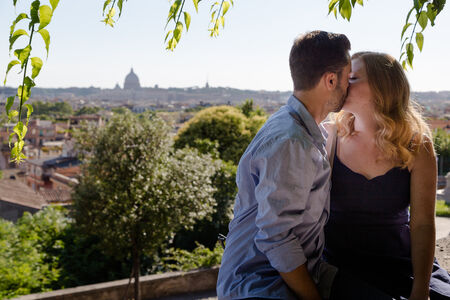 Romantic couple kissing while on a vacation photoshoot in Rome