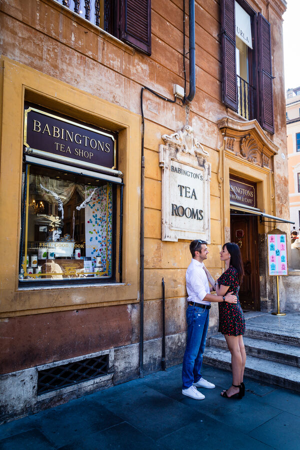 Couple holidng each other near Babington's Tea Shop in Piazza di Spagna Rome