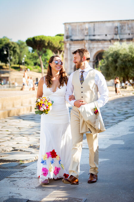 Newly-wed couple strolling in the Colosseum area 